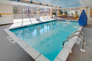 a large swimming pool with blue water at Fairfield Inn & Suites by Marriott Rehoboth Beach in Rehoboth Beach