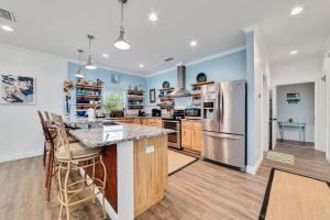 a kitchen with blue walls and wooden countertops at Walk to Beach, Secluded, Gazebo with Grill, 1GiG WiFi, Washer and Dryer, Games in Gulf Shores