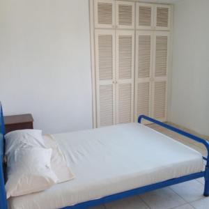 Bett in einem Zimmer mit weißer Tür in der Unterkunft Playa Azul in Tonsupa