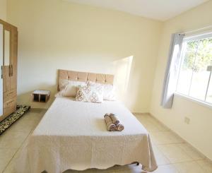 a bedroom with a bed with two shoes on it at casa da cris in Miguel Pereira