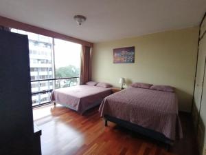 1 dormitorio con 2 camas y ventana grande en Apartamento 908 Cortijo Reforma zona 9 en Guatemala