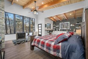 a bedroom with a bed and a kitchen at Whispering Pines - Lakeside in High Hill