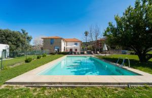 a swimming pool in a yard with a house at Casas de Vila Pouca in Mondim de Basto