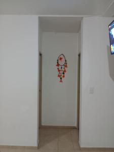 a room with a white wall with a clock on it at Casa Chardonnay in Luzuriaga