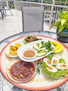 a table topped with plates of food on a table at Hotel Seri Malaysia Seremban in Seremban