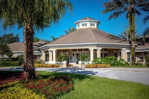 a building with a palm tree in front of it at Pool Home in Famous Windsor Palms Resort 4 Miles to Disney, Free Resort Amenities in Kissimmee