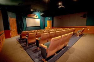 an empty auditorium with chairs and a blank screen at Pool Home in Famous Windsor Palms Resort 4 Miles to Disney, Free Resort Amenities in Kissimmee