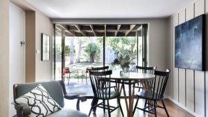 a dining room with a table and chairs at Beach Vista - A Designer Delight Oposite The Beach in Pearl Beach