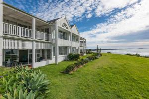 an exterior view of a large house with a grassy yard at Quarterdeck 18 in Lennox Head