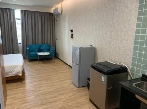 a hospital room with a refrigerator and a bed at Joy Hotel in Phnom Penh