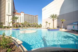 a large swimming pool in front of a building at Some Beach Some Where at Laketown Wharf #825 by Nautical Properties in Panama City Beach