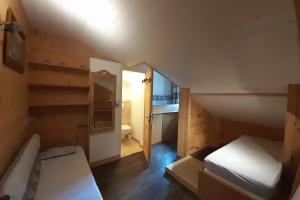 a small room with a bed and a bathroom at Apartment in the center of the village in La Clusaz