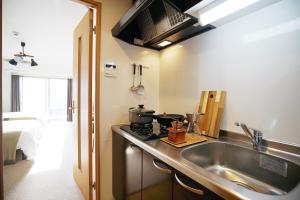a kitchen with a sink and a counter top at 川House難波南-花园町 in Osaka