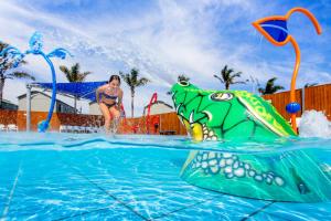 a woman is playing in a water park at BIG4 Easts Beach Holiday Park in Kiama