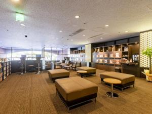 a library with tables and stools in a room at Hotel Wing International Nagoya in Nagoya