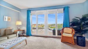 a living room with a couch and a window at Laketown Wharf #317 by Nautical Properties in Panama City Beach