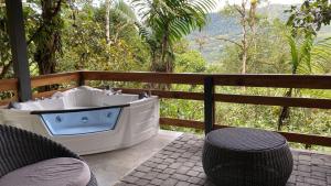 a bath tub on a patio with a view of a forest at Terrabambu Lodge in Mindo