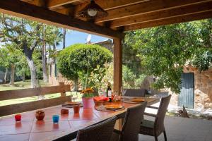 a wooden table with chairs on a patio at Es Pujolet - Alcudia in Port d'Alcudia