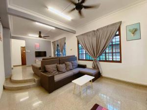 a living room with a couch and a table at C01 Budget Homestay in Tmn Rinting in Masai