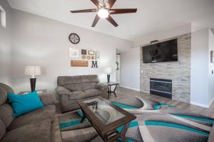 a living room with a couch and a fireplace at Gorgeous Las Vegas home with RV parking in Las Vegas
