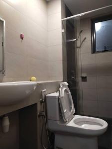 a bathroom with a white toilet and a sink at LOFT E at IMAGO in Kota Kinabalu