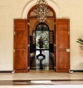 an entrance to a building with a chandelier at Heenatigala Walawwa in Talpe +44 photos