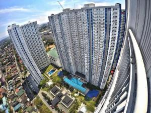 an aerial view of tall buildings in a city at Chill Staycation at Grass Residences in Manila