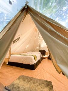 a bedroom with a tent with a bed in it at Tingkat Valley in Ipoh