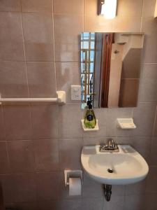 a bathroom with a sink and a mirror at Casa Orestes - Hermosa casa cerca del Centro de Oaxaca in Oaxaca City