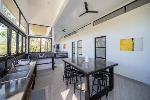 an open kitchen with a large island with bar stools at Vista Loma Estate in San Isidro