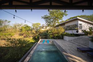 a swimming pool in the backyard of a house at Vista Loma Estate in San Isidro