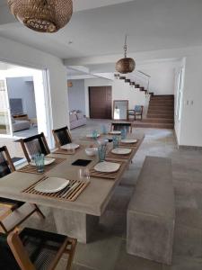 una grande sala da pranzo con un lungo tavolo e sedie di Hermosa Casa de Playa a Escuintla