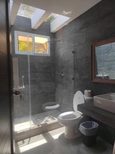 a bathroom with a shower and a toilet and a sink at Hermosa Casa de Playa in Escuintla