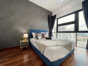 a bedroom with a blue bed and a large window at Pacific Tower Petaling Jaya Near Jaya One, University Malaya, Columbia Hospital By My Homez in Petaling Jaya