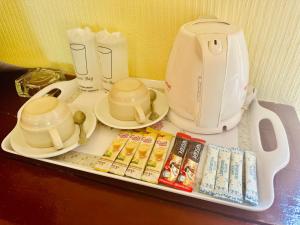 a tray with a coffee maker and a tea kettle at Da Kanda Villa Beach Resort in Thong Sala