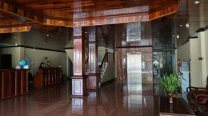 a large room with a wooden ceiling and a hallway at Lisha The Grand Riverside Hotel in Vang Vieng