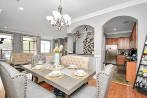 a dining room and living room with a table and chairs at 3BR 3Ba Upscale Luxury Home in The Heights in Houston