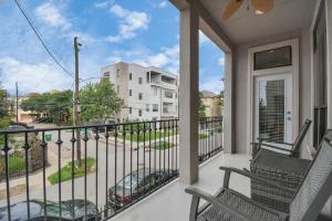 a balcony with two chairs and a view of a building at 3BR 3Ba Upscale Luxury Home in The Heights in Houston