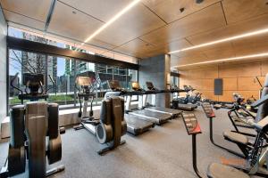 a gym with cardio equipment and a large window at Sakura Serviced Apartments in Melbourne