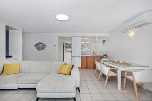 a living room with a couch and a table at Beachcomber Unit 4 7 Dingle Ave in Caloundra