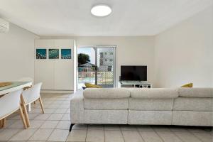 a living room with a couch and a table at Beachcomber Unit 4 7 Dingle Ave in Caloundra