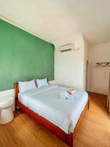 Ein Bett oder Betten in einem Zimmer der Unterkunft Renjana Beach House