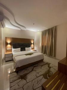 a bedroom with a large bed with a stone rug at Orient House in Hail