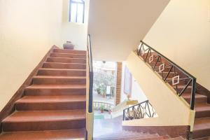a staircase in a home with wooden floors at FabHotel Prime Pool Point Highland, Candolim Beach in Candolim