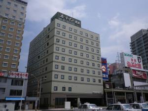 un grand bâtiment avec un panneau en haut dans l'établissement Hotel Route-Inn Aomori Ekimae, à Aomori