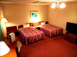 Una cama o camas en una habitación de Shingu UI Hotel