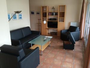 a living room with couches and a coffee table at Villa Hildegard Appartement 2 in Binz
