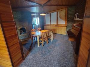 a dining room with a table and a fireplace at EXCLUSIVE HOUSE 400m2 - Sauna, BBQ, fireplace in Narva