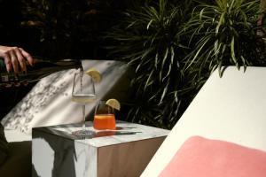 a person pouring a drink into a wine glass at Munno Villa in Canggu