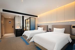 Voodi või voodid majutusasutuse Hampton by Hilton Shenzhen North Station toas